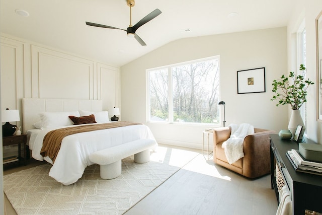 bedroom with vaulted ceiling, light hardwood / wood-style floors, and ceiling fan