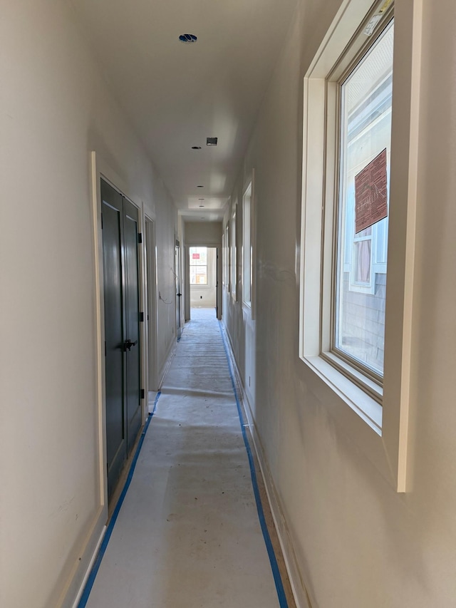 hallway with concrete flooring