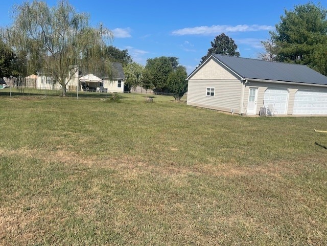 view of yard with a garage and an outdoor structure