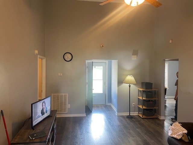 entrance foyer with dark wood-type flooring, ceiling fan, and a high ceiling