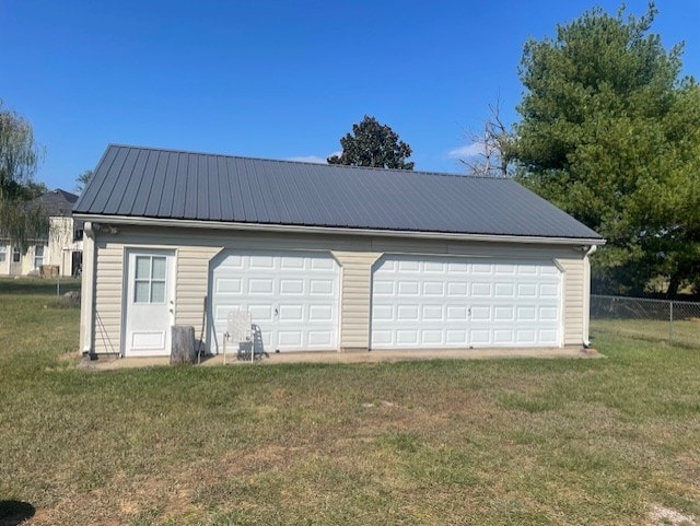 garage featuring a lawn