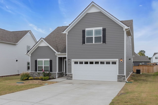 view of front of house featuring central AC unit, a garage, and a front lawn