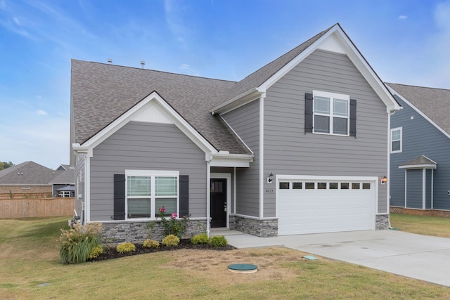 craftsman-style home with a front lawn and a garage