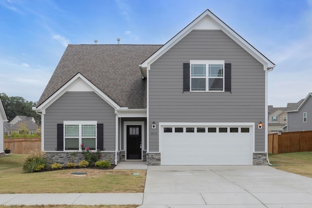 view of front of house with a garage and a front yard