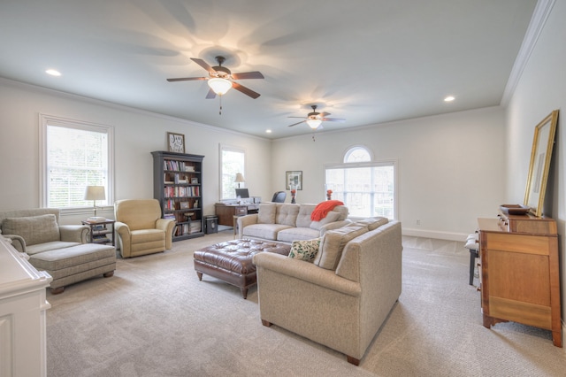 living room with light carpet, crown molding, and ceiling fan