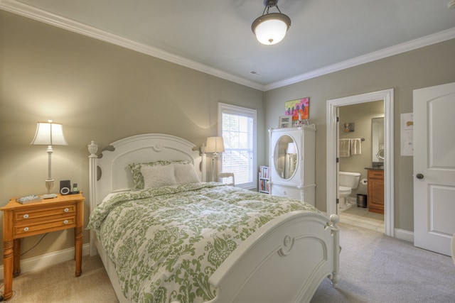 carpeted bedroom with ornamental molding and ensuite bathroom