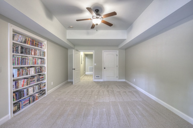 interior space with light carpet and ceiling fan