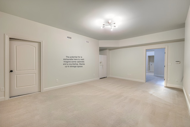 empty room with light colored carpet