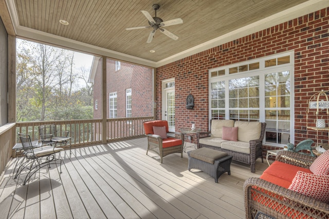 sunroom with a wealth of natural light, wooden ceiling, and ceiling fan