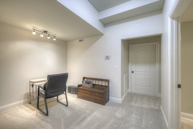 home office featuring track lighting and light colored carpet