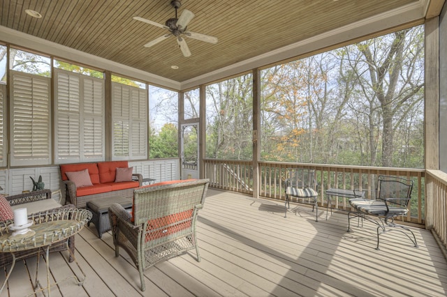 sunroom / solarium featuring ceiling fan, wooden ceiling, and a healthy amount of sunlight