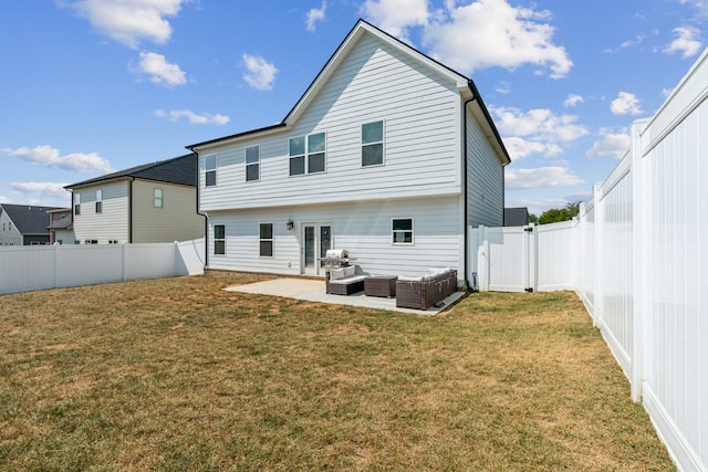 back of property with a yard, a patio, and an outdoor living space