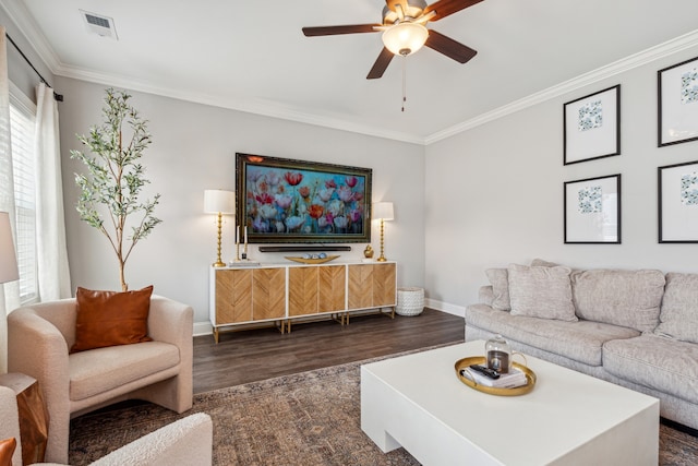 living room with dark hardwood / wood-style floors, crown molding, and ceiling fan