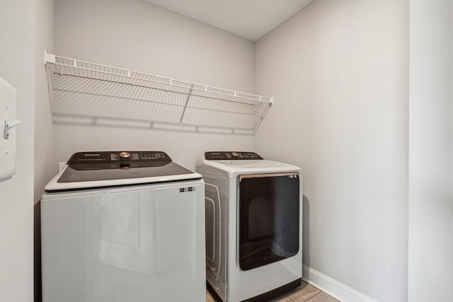 washroom featuring independent washer and dryer and light tile patterned flooring