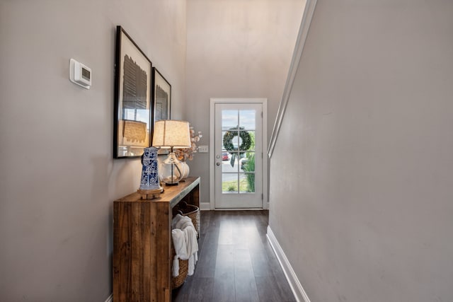 hall with ornamental molding and dark hardwood / wood-style floors