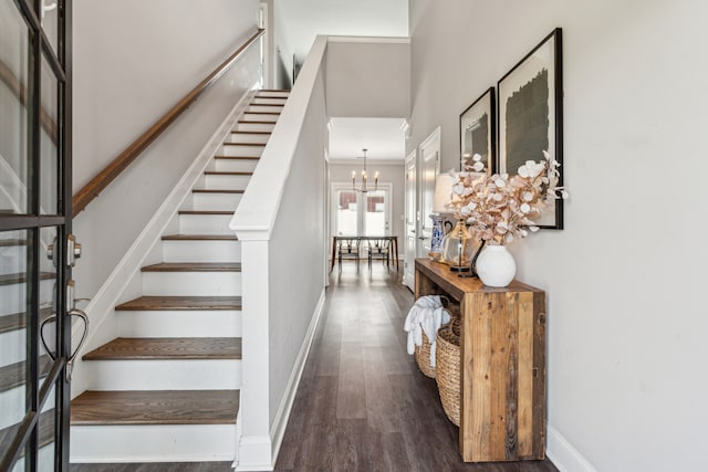 entrance foyer featuring dark hardwood / wood-style floors and an inviting chandelier