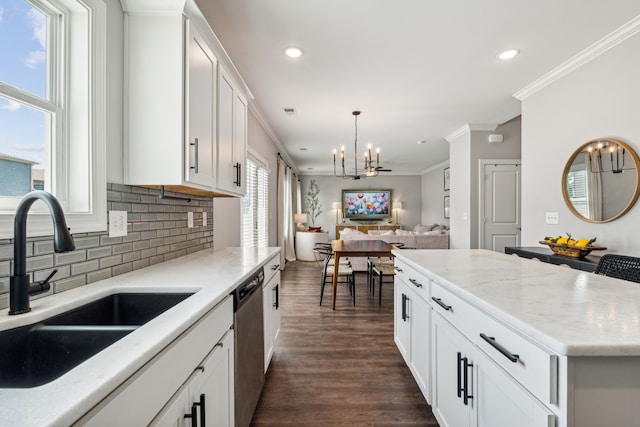 kitchen featuring ornamental molding, dark hardwood / wood-style flooring, sink, white cabinets, and dishwasher