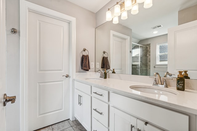 bathroom featuring walk in shower, vanity, and tile patterned flooring