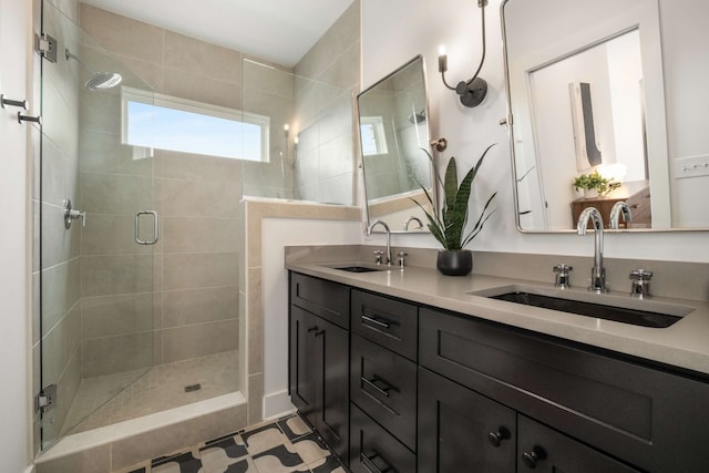 bathroom featuring tile patterned flooring, vanity, and a shower with door