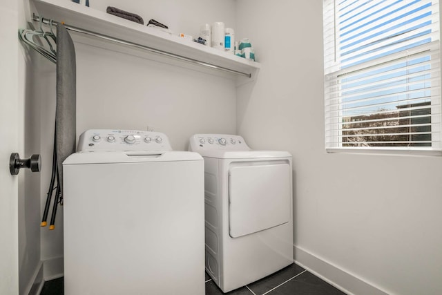 laundry area featuring dark tile patterned floors and washer and dryer