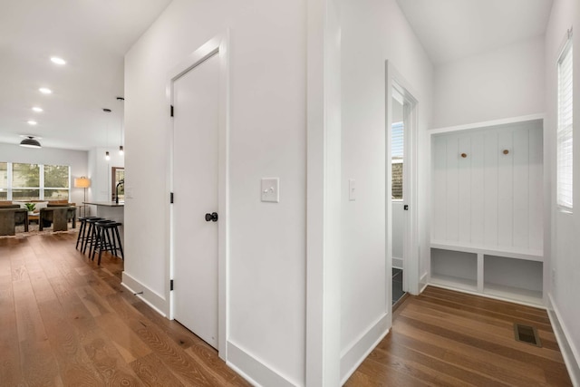 hallway with hardwood / wood-style flooring