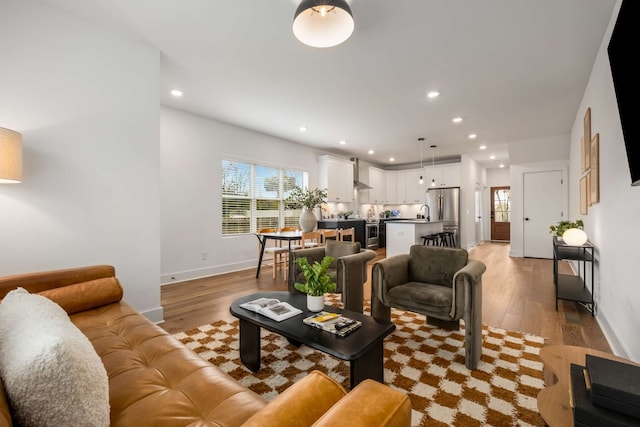 living room with sink and light hardwood / wood-style floors