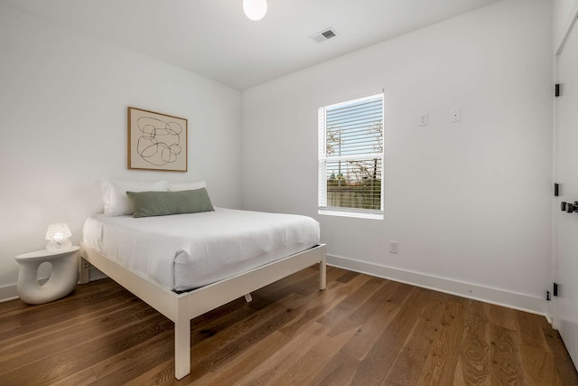 bedroom with hardwood / wood-style flooring