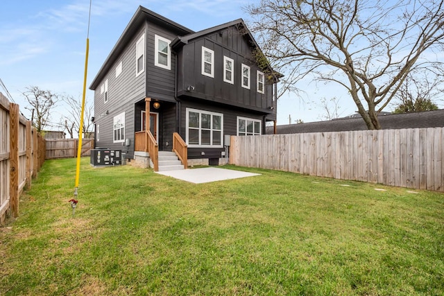 rear view of property with a yard and a patio