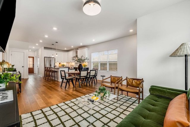 living room with hardwood / wood-style flooring and sink