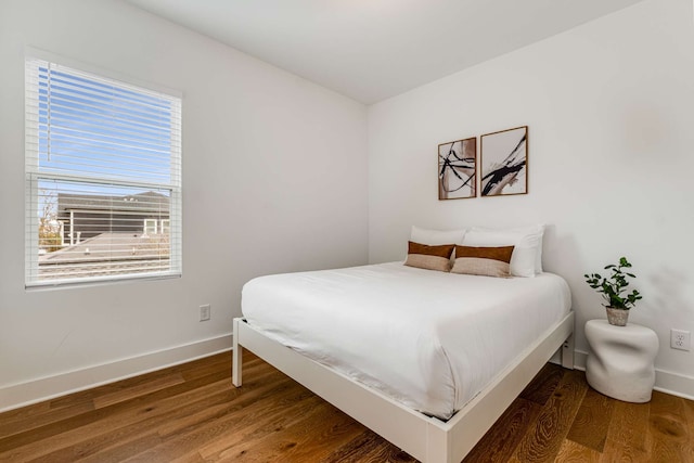 bedroom with dark wood-type flooring