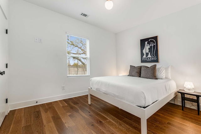 bedroom featuring dark hardwood / wood-style flooring