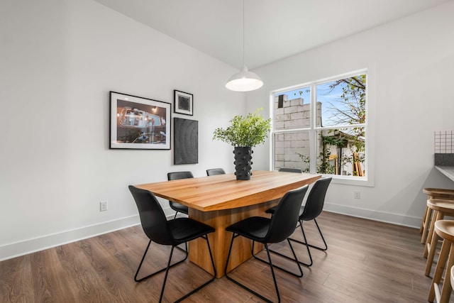 dining area with dark hardwood / wood-style flooring