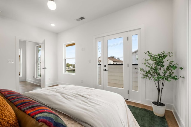 bedroom with dark hardwood / wood-style flooring and access to exterior