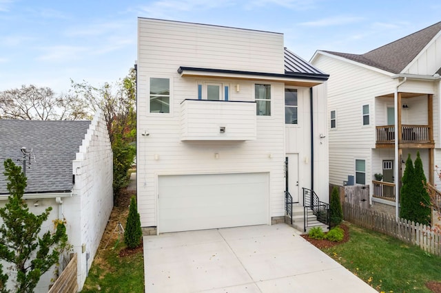 view of front of house featuring a balcony and a garage