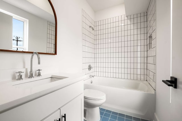 full bathroom with toilet, vanity, and tiled shower / bath