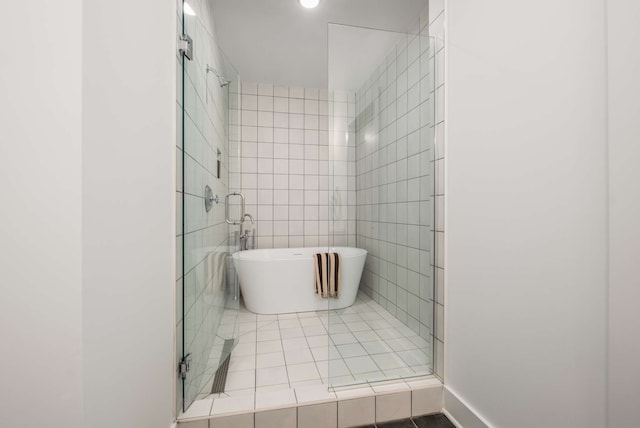 bathroom featuring shower with separate bathtub