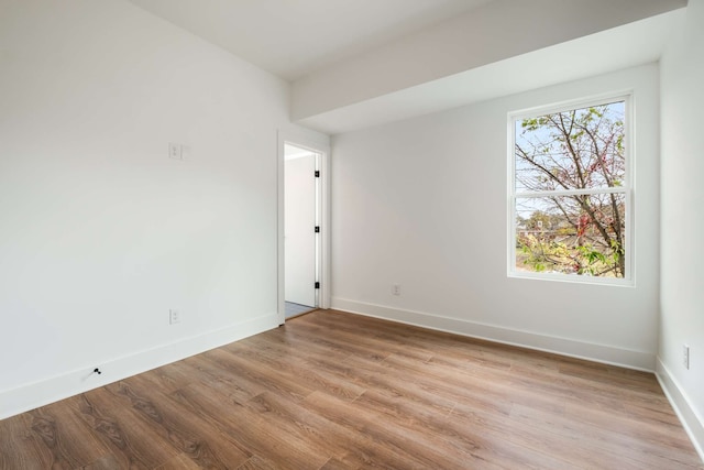 spare room with light hardwood / wood-style flooring