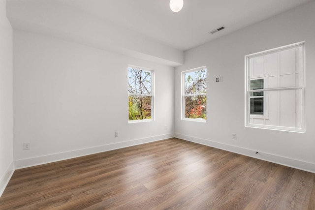 unfurnished room with dark hardwood / wood-style floors