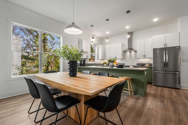 dining area with wood-type flooring and sink