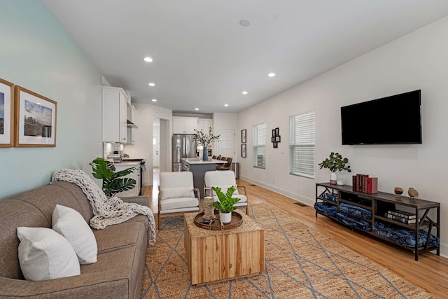 living room with light hardwood / wood-style flooring