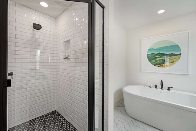 bathroom featuring separate shower and tub