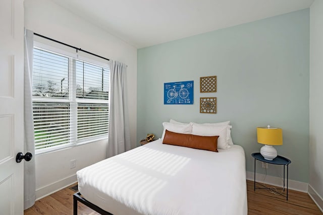 bedroom featuring light wood-type flooring and multiple windows