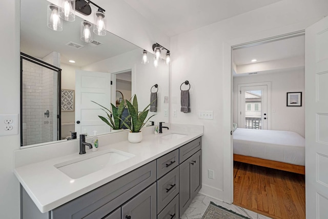 bathroom featuring a shower with shower door, wood-type flooring, and vanity