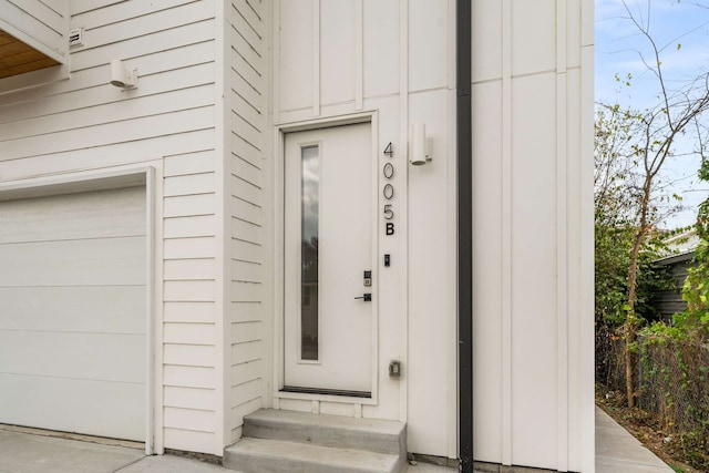 view of exterior entry with a garage