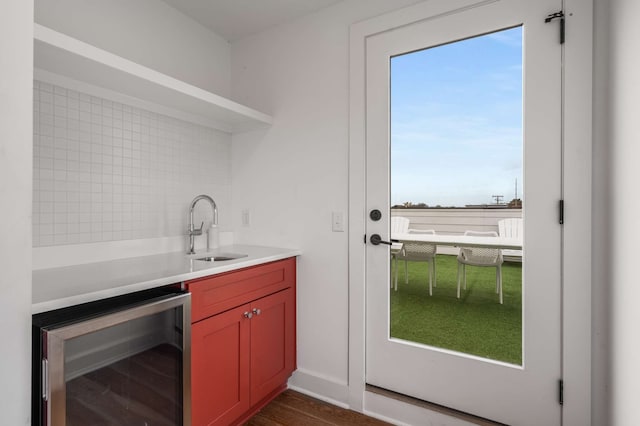 interior space featuring dark hardwood / wood-style floors, sink, and wine cooler