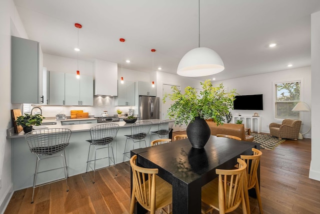 dining space featuring dark hardwood / wood-style floors and sink