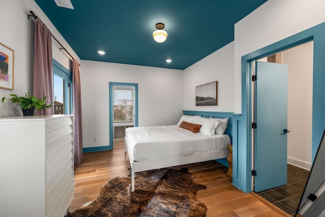 bedroom with dark hardwood / wood-style floors