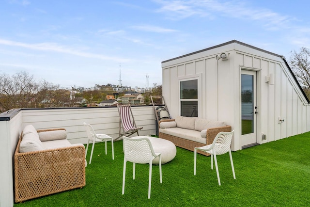 view of outdoor structure with outdoor lounge area and a yard