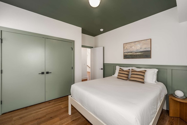 bedroom featuring wood-type flooring and a closet