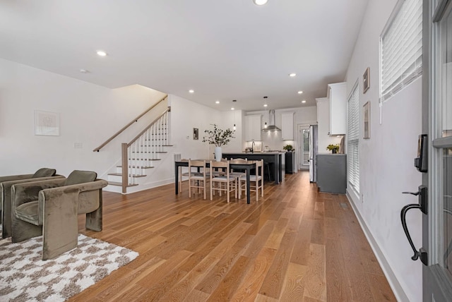 dining space with light hardwood / wood-style flooring and sink